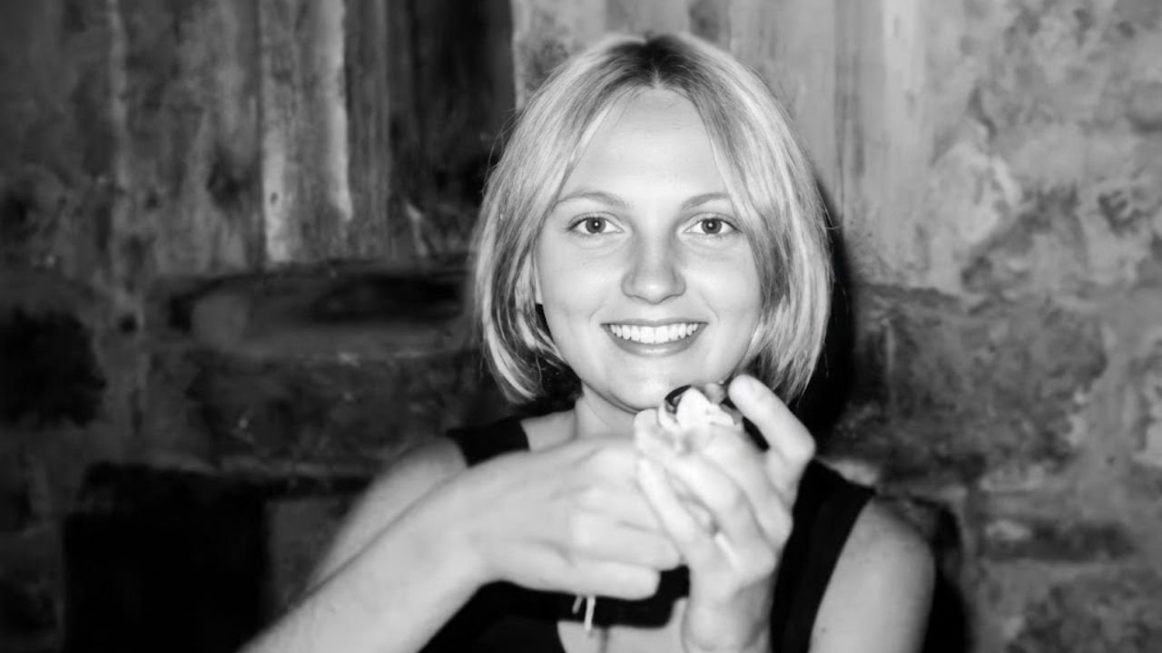 A detailed, sharp archival black and white portrait photograph of 19-year-old Reet Jurvetson (Jane Doe 59) smiling, looking directly at the camera, with a simplified stone wall background.